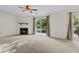 Inviting living room featuring a fireplace, ceiling fan, and access to an outdoor patio at 7950 Parklane Ct # C, North Charleston, SC 29418