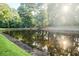 Beautiful pond reflecting sunlight through the trees at 7950 Parklane Ct # C, North Charleston, SC 29418