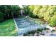 Aerial shot of Community tennis court surrounded by lush trees at 7950 Parklane Ct # C, North Charleston, SC 29418