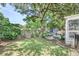Spacious backyard featuring a lush lawn, mature trees, patio area, and space for outdoor activities at 938 Sea Gull Dr, Mount Pleasant, SC 29464