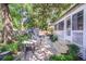 Landscaped backyard featuring a stone patio, comfortable seating, and screened porch for enjoying the outdoors at 938 Sea Gull Dr, Mount Pleasant, SC 29464