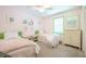 Cozy bedroom features twin beds with soft pink bedding, complemented by green accents and ample storage at 938 Sea Gull Dr, Mount Pleasant, SC 29464