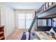 Comfortable bedroom features a dark wood bunk bed, closet, and bright window for natural light at 938 Sea Gull Dr, Mount Pleasant, SC 29464