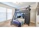 Charming bedroom with a dark wood bunk bed, fun bedding, and window overlooking the yard at 938 Sea Gull Dr, Mount Pleasant, SC 29464