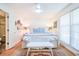 Bright bedroom with a queen-sized bed, white wainscotting, ceiling fan, and access to the ensuite bathroom at 938 Sea Gull Dr, Mount Pleasant, SC 29464