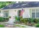 Charming single-story home with a landscaped front yard and patriotic American flag at 938 Sea Gull Dr, Mount Pleasant, SC 29464