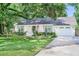 Inviting home featuring a manicured lawn, white exterior, shuttered windows, and a welcoming front porch at 938 Sea Gull Dr, Mount Pleasant, SC 29464