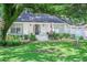 Home with a lush green lawn, white exterior, black door, and an American flag at 938 Sea Gull Dr, Mount Pleasant, SC 29464