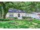 Inviting single-story home with lush landscaping, mature tree, and classic architectural details at 938 Sea Gull Dr, Mount Pleasant, SC 29464