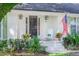 Home with an American flag, landscaped yard, white chairs, and a charming front porch at 938 Sea Gull Dr, Mount Pleasant, SC 29464