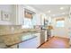 Sunlit kitchen showcasing granite countertops and stainless steel appliances, perfect for culinary enthusiasts at 938 Sea Gull Dr, Mount Pleasant, SC 29464
