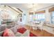 Bright living room with a cozy breakfast nook, fireplace, and large windows providing views of the outdoors at 938 Sea Gull Dr, Mount Pleasant, SC 29464