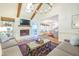 Cozy living room features a stone fireplace, beamed ceilings, skylights, and views into the open-plan kitchen at 938 Sea Gull Dr, Mount Pleasant, SC 29464