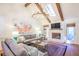 Comfortable living room with stylish sofas, a stone fireplace, hardwood floors, and a skylight at 938 Sea Gull Dr, Mount Pleasant, SC 29464