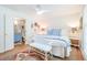 Comfortable bedroom with elegant furnishings and an open doorway to the bathroom at 938 Sea Gull Dr, Mount Pleasant, SC 29464