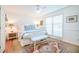 Serene bedroom with hardwood floors, ceiling fan, and ample natural light from large windows at 938 Sea Gull Dr, Mount Pleasant, SC 29464