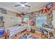 Fun bedroom featuring a ceiling fan, desk, and shelves with toys and books at 1004 Providence Way, Summerville, SC 29483