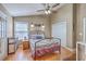 Cozy bedroom featuring a metal frame bed, ceiling fan, and a window with natural light at 1004 Providence Way, Summerville, SC 29483