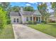 Charming home featuring a well-maintained front yard, long driveway, and inviting front porch at 1004 Providence Way, Summerville, SC 29483