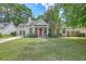 Charming single-Gathering home featuring a well-manicured lawn and a welcoming red front door at 1004 Providence Way, Summerville, SC 29483