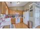 Traditional kitchen features wood cabinets, white appliances, and a cozy breakfast nook area at 1004 Providence Way, Summerville, SC 29483