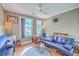 Comfortable living room with a futon, television, and natural light from the two windows at 1004 Providence Way, Summerville, SC 29483