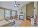 Cozy living room with high ceilings, a ceiling fan, fireplace, and comfortable seating at 1004 Providence Way, Summerville, SC 29483