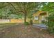 Backyard shed offers additional storage with a window and a small covered patio at 1004 Providence Way, Summerville, SC 29483