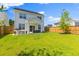 Spacious backyard with a well-manicured lawn, privacy fence, string lights, patio furniture, and a grill at 101 Guernsey Ln, Summerville, SC 29483
