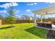 Large backyard with covered patio and privacy fence offers plenty of space for outdoor activities and relaxation at 101 Guernsey Ln, Summerville, SC 29483