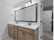 Bright bathroom features a double sink vanity with stone counters, modern fixtures, and a large, framed mirror at 101 Guernsey Ln, Summerville, SC 29483