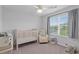 Bright Bedroom with crib, rocking chair, elephant, side table, and large window for plenty of natural light at 101 Guernsey Ln, Summerville, SC 29483