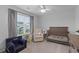 Bedroom with a crib, comfortable chair, a 'Theo' seat, and a large window overlooking the yard at 101 Guernsey Ln, Summerville, SC 29483