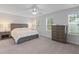 Primary bedroom with neutral tones, natural light, and wood furniture at 101 Guernsey Ln, Summerville, SC 29483