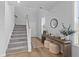 Bright entryway with a wooden console table, decorative mirror, and carpeted stairs at 101 Guernsey Ln, Summerville, SC 29483