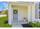 Inviting front entrance with a wreath on the gray door and decorative potted plant at 101 Guernsey Ln, Summerville, SC 29483