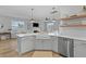 Open floor plan with a kitchen island, white countertops, stainless appliances, and a farmhouse sink at 101 Guernsey Ln, Summerville, SC 29483