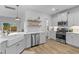 Bright kitchen features white cabinets, stainless appliances, wood floors, and open shelving at 101 Guernsey Ln, Summerville, SC 29483