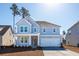 Charming two-story home with blue siding, white trim, and a two-car garage at 1029 Riverbed Retreat Ln, Summerville, SC 29485
