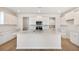 Bright, modern kitchen with white cabinets, quartz countertops, stainless steel appliances, and a center island at 1029 Riverbed Retreat Ln, Summerville, SC 29485