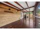 This covered back porch features a stained wood floor and wooden accents, perfect for relaxed outdoor living and entertaining at 1034 Steelechase Ln, Hanahan, SC 29410