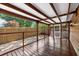 This beautiful outdoor back porch features a vaulted ceiling, wooden deck, and is partially screened-in for comfortable entertaining at 1034 Steelechase Ln, Hanahan, SC 29410
