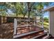 This backyard deck features wooden steps and railing with trees overhead providing shade for outdoor enjoyment at 1034 Steelechase Ln, Hanahan, SC 29410