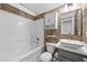 Bathroom featuring tub and shower, vessel sink vanity, and built in shelving with accent tiles at 1034 Steelechase Ln, Hanahan, SC 29410