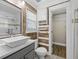Bathroom vanity with white vessel sink, decorative mirror and mosaic tile accents leading to the walk-in closet at 1034 Steelechase Ln, Hanahan, SC 29410