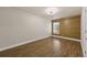 Bedroom with wood-look flooring and accent wall, offering a blend of style and comfort at 1034 Steelechase Ln, Hanahan, SC 29410