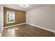 This bedroom features wood paneling, vinyl floors, and a window that provides natural light, creating a warm and inviting atmosphere at 1034 Steelechase Ln, Hanahan, SC 29410