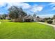 Sprawling front yard with lush green grass and mature trees adds to the home's curb appeal at 1034 Steelechase Ln, Hanahan, SC 29410