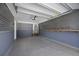 The garage features metallic walls and finished floors, offering a clean and modern workspace for vehicle storage and projects at 1034 Steelechase Ln, Hanahan, SC 29410