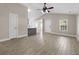 Light-filled living room featuring wood-look flooring, vaulted ceilings, and an open floor plan at 1034 Steelechase Ln, Hanahan, SC 29410